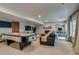 Finished basement includes a large seating area with a fireplace, air hockey, and a large window at 8927 Green Meadows Ln, Highlands Ranch, CO 80126