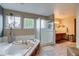 Bright bathroom with a soaking tub, separate shower, and ample counter space with modern finishes at 8927 Green Meadows Ln, Highlands Ranch, CO 80126