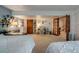 Spacious bedroom furnished with two beds, two desks, shelving, and glass door leading to other room at 8927 Green Meadows Ln, Highlands Ranch, CO 80126
