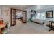 Spacious bedroom features two beds, a desk, and doors leading to the basement at 8927 Green Meadows Ln, Highlands Ranch, CO 80126