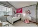 Bedroom with a Taylor Swift theme, papasan chair, and large window for ample natural light at 8927 Green Meadows Ln, Highlands Ranch, CO 80126