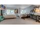 Spacious bedroom is furnished with two beds, a desk, and a large window providing natural light at 8927 Green Meadows Ln, Highlands Ranch, CO 80126