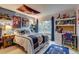 Blue-themed bedroom with posters, shelving, and desk next to a window for ample natural light at 8927 Green Meadows Ln, Highlands Ranch, CO 80126