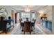Sophisticated dining room with a decorative rug, chandelier, and stylish furnishings for entertaining at 8927 Green Meadows Ln, Highlands Ranch, CO 80126