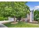 Beautiful home with brick and siding exterior, mature tree, and well-maintained front yard at 8927 Green Meadows Ln, Highlands Ranch, CO 80126