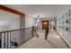 Upstairs hallway features iron railing and natural light at 8927 Green Meadows Ln, Highlands Ranch, CO 80126