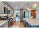 Modern kitchen features stainless appliances, granite countertops, and subway tile backsplash at 8927 Green Meadows Ln, Highlands Ranch, CO 80126