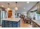 Open kitchen flows into living and dining areas with stainless appliances, granite counters and breakfast bar at 8927 Green Meadows Ln, Highlands Ranch, CO 80126