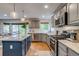 Updated kitchen featuring stainless steel appliances, granite countertops, and center island at 8927 Green Meadows Ln, Highlands Ranch, CO 80126