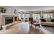 Cozy living room with brick fireplace, hardwood floors, and comfortable seating at 8927 Green Meadows Ln, Highlands Ranch, CO 80126