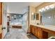 Brightly lit main bathroom with soaking tub, glass enclosed shower, and double vanity at 8927 Green Meadows Ln, Highlands Ranch, CO 80126