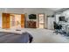 Spacious main bedroom with attached office, en suite bath, and large picture window for ample natural light at 8927 Green Meadows Ln, Highlands Ranch, CO 80126