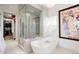 Elegant bathroom with a soaking tub, glass-enclosed shower, and a walk-in closet at 865 Delaware St, Denver, CO 80204