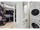 Organized closet with built-in shelves, drawers, and a laundry area for added convenience at 865 Delaware St, Denver, CO 80204