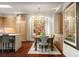 Stylish dining area with a large window, chandelier, and an open view to the kitchen at 865 Delaware St, Denver, CO 80204
