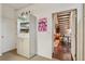 A hallway with a display cabinet that leads to a living area with wood floors and a staircase at 865 Delaware St, Denver, CO 80204
