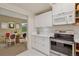 Clean kitchen with stainless steel appliances and white cabinetry, plus an eat-in area at 865 Delaware St, Denver, CO 80204