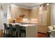 Modern kitchen featuring stainless steel appliances, island seating, and ample cabinet space at 865 Delaware St, Denver, CO 80204