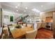 Bright open concept living, dining, and kitchen space with a modern staircase and hardwood floors at 865 Delaware St, Denver, CO 80204
