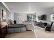 Relaxing main bedroom with a comfortable seating area, large windows, and a mounted TV at 865 Delaware St, Denver, CO 80204