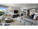 Comfortable and well-lit main bedroom featuring a seating area, large windows, and modern lighting fixture at 865 Delaware St, Denver, CO 80204