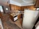 Kitchen featuring wood cabinets, a white dishwasher, and an open layout at 3231 S Estes St, Lakewood, CO 80227