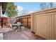 Private backyard patio with dining set and exterior storage unit, ideal for outdoor enjoyment and storage at 5959 S Willow Way, Greenwood Village, CO 80111