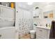 Bathroom features a washer and dryer, floral shower curtain, vanity, and medicine cabinet at 5959 S Willow Way, Greenwood Village, CO 80111