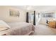 Bright bedroom with large windows, ceiling fan, carpet, and a convenient workspace with desk at 5959 S Willow Way, Greenwood Village, CO 80111