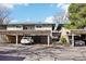 Exterior view of carport parking area with assigned parking spaces and well-maintained landscaping at 5959 S Willow Way, Greenwood Village, CO 80111