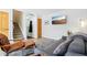 Relaxing living room featuring a sofa, a television, and a staircase leading to the upper level at 5959 S Willow Way, Greenwood Village, CO 80111