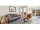 Comfortable living room featuring a sofa, chair, and sliding glass doors to the backyard at 5959 S Willow Way, Greenwood Village, CO 80111