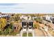 Aerial view of modern homes in a neighborhood with mature trees and blue sky at 3437 W 17Th Ave, Denver, CO 80204