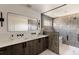Modern bathroom featuring a glass-enclosed shower, sleek double vanity, and stylish gray tile at 3437 W 17Th Ave, Denver, CO 80204