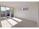 Bright and airy bedroom with neutral carpet, modern horizontal windows and glass doors to a deck at 3437 W 17Th Ave, Denver, CO 80204