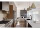Contemporary kitchen with stainless steel appliances, a large island with sink, and an open view to the living area at 3437 W 17Th Ave, Denver, CO 80204