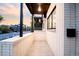 Contemporary covered porch with sleek black accents, and a glimpse of modern street at 3437 W 17Th Ave, Denver, CO 80204
