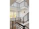 Modern staircase with black metal railings and contemporary lighting fixtures at 3437 W 17Th Ave, Denver, CO 80204