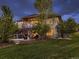 Spacious backyard featuring a multi-level deck, patio, and lush lawn surrounded by mature trees at 5441 Twilight Way, Parker, CO 80134