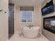 Luxurious bathroom with a soaking tub, fireplace, TV, and a separate glass shower at 5441 Twilight Way, Parker, CO 80134