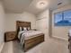 Cozy bedroom with neutral carpet, natural wood furniture, and large windows at 5441 Twilight Way, Parker, CO 80134