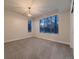 Bright bedroom with plush carpet, two windows, and natural light at 5441 Twilight Way, Parker, CO 80134