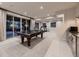 Spacious game room with a ping pong table, gym equipment, and sliding doors at 5441 Twilight Way, Parker, CO 80134
