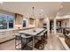 Gourmet kitchen with an oversized island and seating for six, flowing into other living spaces at 5441 Twilight Way, Parker, CO 80134