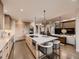 Modern kitchen with large island, stainless steel appliances, and open layout at 5441 Twilight Way, Parker, CO 80134
