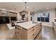 Open kitchen with a large island and seamless access to the fireplace and living area at 5441 Twilight Way, Parker, CO 80134