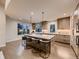 Bright, open kitchen with large island, modern lighting, and stainless appliances at 5441 Twilight Way, Parker, CO 80134