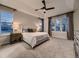 Spacious primary bedroom with large windows, soft lighting, and a modern ceiling fan at 5441 Twilight Way, Parker, CO 80134