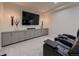 Home theater with leather recliners, a large screen TV, and built-in cabinets at 5441 Twilight Way, Parker, CO 80134