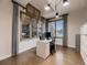 Well-lit home office with built-in storage, hardwood floors, and large shuttered windows at 5441 Twilight Way, Parker, CO 80134